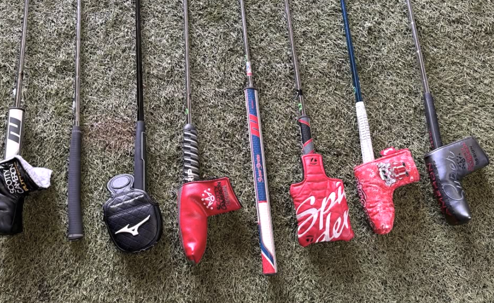 Row of putters with headcovers inside the shop